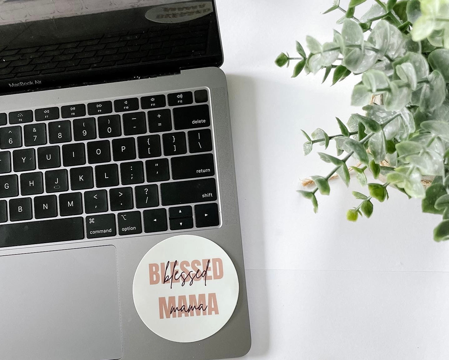 Blessed mama sticker pictured on laptop
