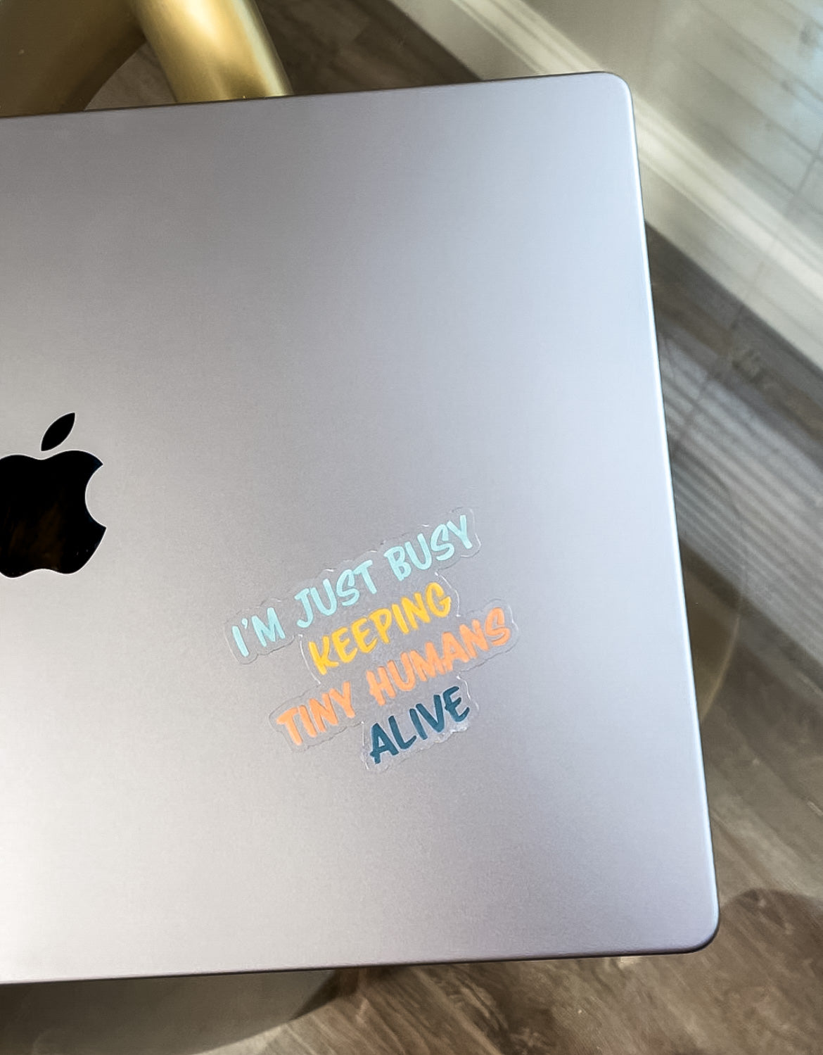 I'm just busy keeping tiny humans alive clear sticker pictured on laptop